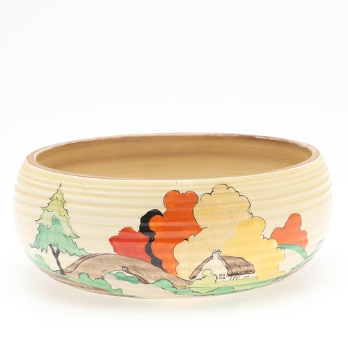 608 - CLARICE CLIFF ART DECO BOWL. A circular bowl painted with a cottage by a bridge and within a landsca... 