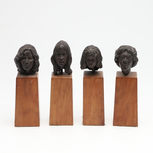 624 - SET OF BRONZE CONTEMPORARY BUSTS. A set of four small bronze busts of women, each mounted on  wooden... 