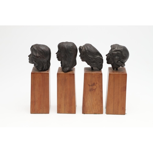 624 - SET OF BRONZE CONTEMPORARY BUSTS. A set of four small bronze busts of women, each mounted on  wooden... 