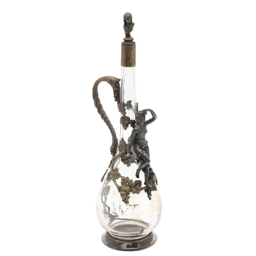 671 - FRENCH GILT METAL CLARET JUG. A slender glass claret jug, applied with gilt metal mounts including a... 