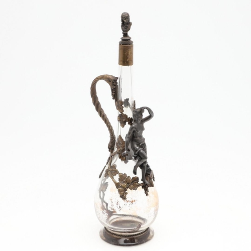 671 - FRENCH GILT METAL CLARET JUG. A slender glass claret jug, applied with gilt metal mounts including a... 