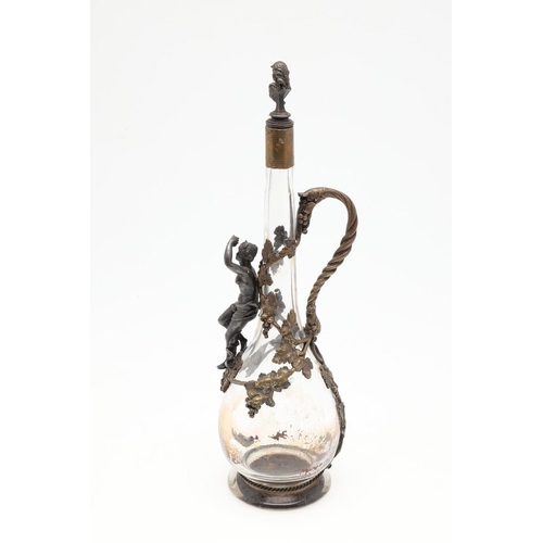 671 - FRENCH GILT METAL CLARET JUG. A slender glass claret jug, applied with gilt metal mounts including a... 