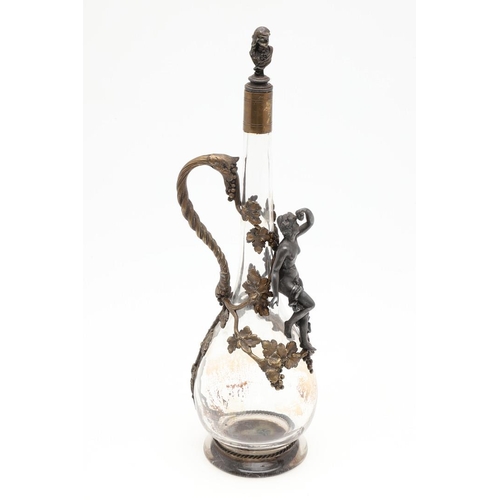 671 - FRENCH GILT METAL CLARET JUG. A slender glass claret jug, applied with gilt metal mounts including a... 