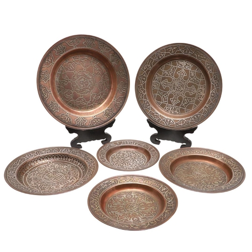 735 - SET OF PERSIAN COPPER & SILVER INLAID DISHES. Probably early 20thc, a set of six graduated copper di... 