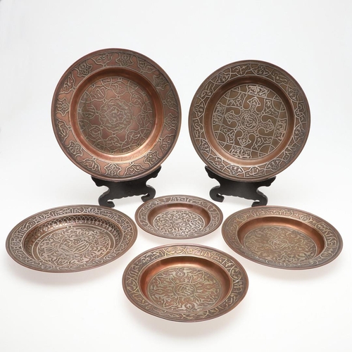 735 - SET OF PERSIAN COPPER & SILVER INLAID DISHES. Probably early 20thc, a set of six graduated copper di... 