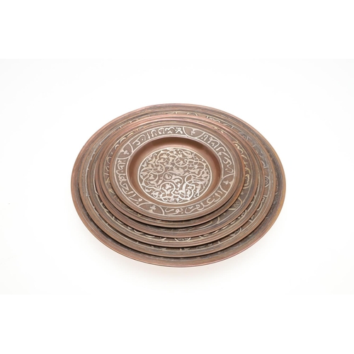 735 - SET OF PERSIAN COPPER & SILVER INLAID DISHES. Probably early 20thc, a set of six graduated copper di... 