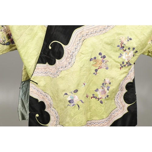 767 - CHINESE EMBROIDERED SILK ROBE. A 3/4 length robe, embroidered with flowers, birds and insects on gre... 