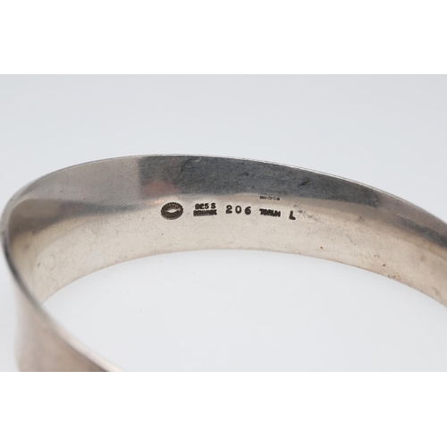 1002 - A SILVER MOEBIUS BANGLE BY GEORG JENSEN. design number 206, with maker's mark and stamped 925 S Denm... 