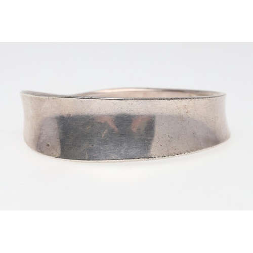 1002 - A SILVER MOEBIUS BANGLE BY GEORG JENSEN. design number 206, with maker's mark and stamped 925 S Denm... 