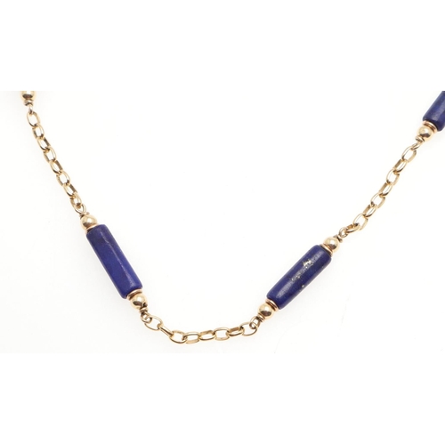 1004 - A LAPIS LAZULI AND GOLD NECKLET. the gold oval link necklet is mounted with lapis lazuli batons, 41.... 