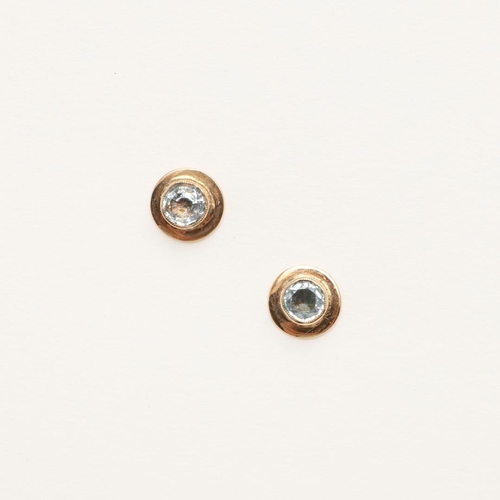 1005 - A PAIR OF AQUAMARINE AND GOLD STUD EARRINGS. each earring formed with a circular-cut aquamarine in a... 