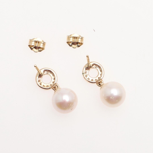 1010 - A PAIR OF CULTURED PEARL AND DIAMOND DROP EARRINGS. each earring mounted with a cultured pearl measu... 