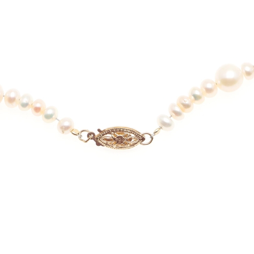 1011 - A CULTURED PEARL AND GOLD BEAD NECKLACE. mounted with cultured pearls measuring approximately 6.5mm,... 