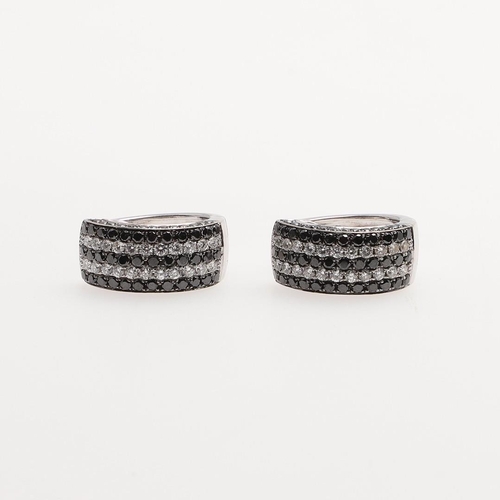 1012 - A PAIR OF DIAMOND HALF HOOP EARRINGS. each earring mounted with alternate rows of circular-cut black... 