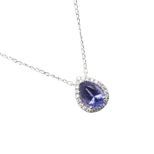 1014 - A TANZANITE AND DIAMOND CLUSTER PENDANT. the pear-shaped tanzanite weighs 1.41 carats and  is set wi... 