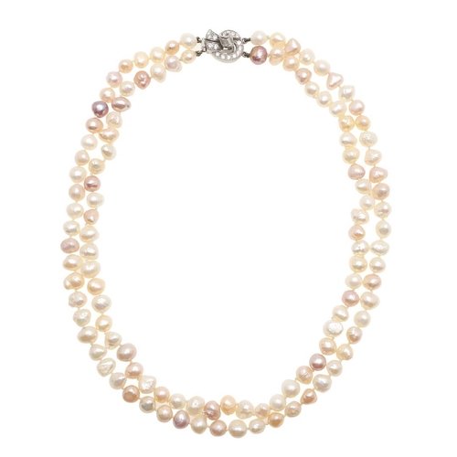 1017 - A CULTURED PEARL AND DIAMOND CHOKER. mounted with two rows of unevenly shaped pink and white pearls,... 