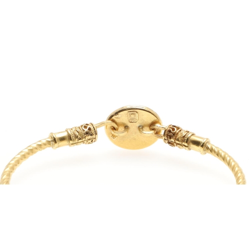 1019 - AN OPAL AND GOLD GOLD BANGLE. mounted with an oval solid white opal on a 21ct gold bangle, with orna... 