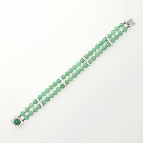 1023 - A JADE AND GOLD BRACELET. formed as two rows of jade beads, with 9ct white gold engraved spacers, wi... 