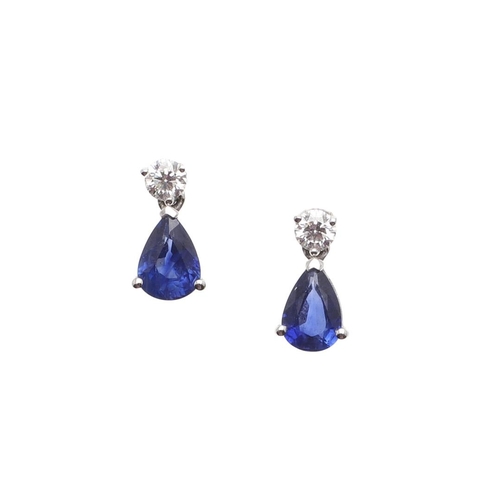 1026 - A PAIR OF SAPPHIRE AND DIAMOND DROP EARRINGS. each earring mounted with a pear-shaped sapphire drop ... 