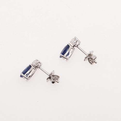 1026 - A PAIR OF SAPPHIRE AND DIAMOND DROP EARRINGS. each earring mounted with a pear-shaped sapphire drop ... 