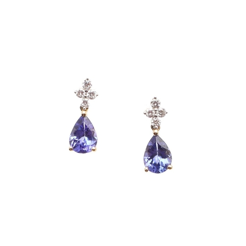 1029 - A PAIR OF TANZANITE AND DIAMOND DROP EARRINGS. each earring mounted with a pear-shaped tanzanite dro... 