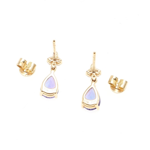 1029 - A PAIR OF TANZANITE AND DIAMOND DROP EARRINGS. each earring mounted with a pear-shaped tanzanite dro... 