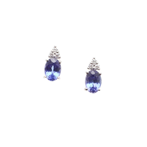 1030 - A PAIR OF TANZANITE AND DIAMOND STUD EARRINGS. each earring mounted with an oval-shaped tanzanite an... 