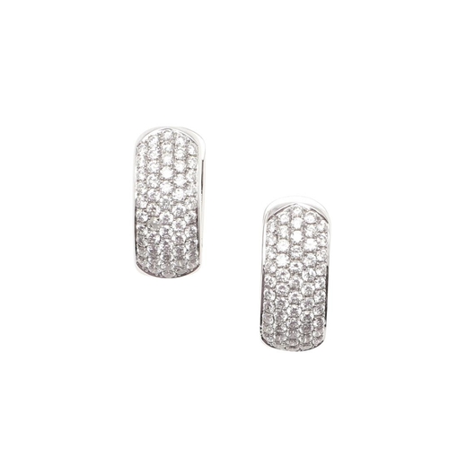 1031 - A PAIR OF DIAMOND EARRINGS. each earring mounted to one side with rows of circular-cut diamonds, in ... 