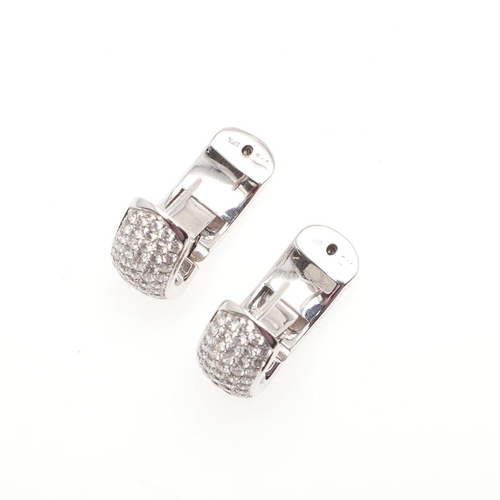 1031 - A PAIR OF DIAMOND EARRINGS. each earring mounted to one side with rows of circular-cut diamonds, in ... 