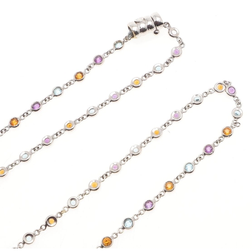 1039 - AN 18CT WHITE GOLD AND GEM SET SPECTACLE NECKLACE. collet set with assorted circular-cut gem stones,... 