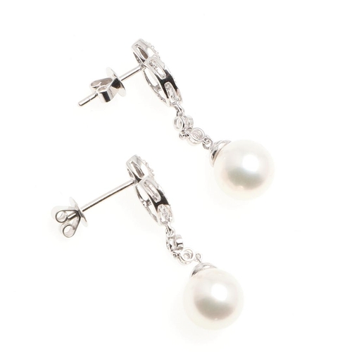 1046 - A PAIR OF CULTURED PEARL AND DIAMOND DROP EARRINGS. each earring set with an Akoya pearl measuring a... 