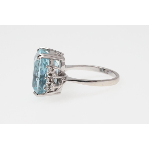 1056 - AN AQUAMARINE AND DIAMOND RING. the oval-shaped aquamarine is set with five circular-cut diamonds to... 