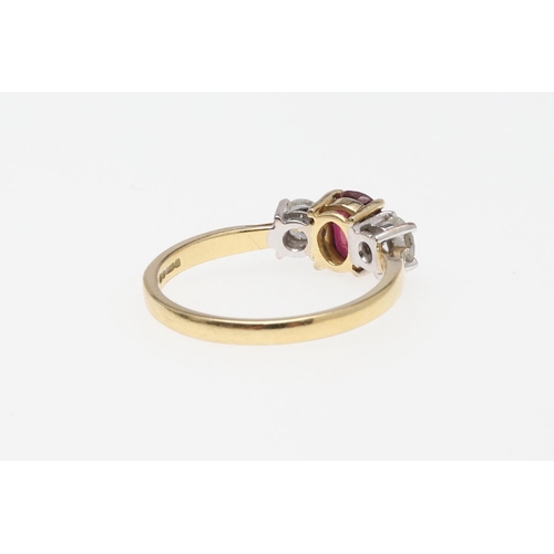 1059 - A RUBY AND DIAMOND THREE STONE RING. the oval-shaped ruby is set with two circular-cut diamonds, in ... 