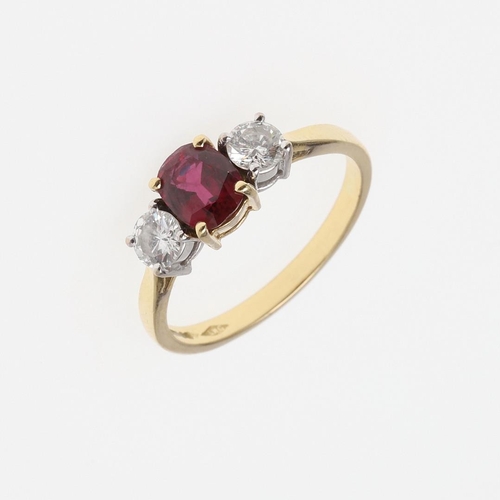 1059 - A RUBY AND DIAMOND THREE STONE RING. the oval-shaped ruby is set with two circular-cut diamonds, in ... 