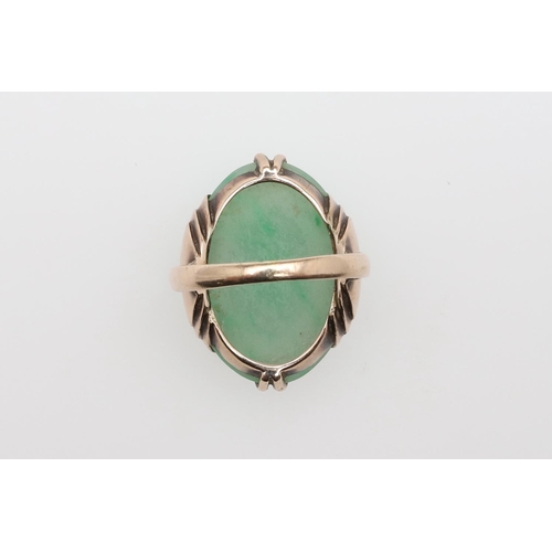 1061 - A JADEITE SINGLE STONE RING. the oval-shaped jadeite cabochon is set in gold, 5.7 grams. Size E

Acc... 