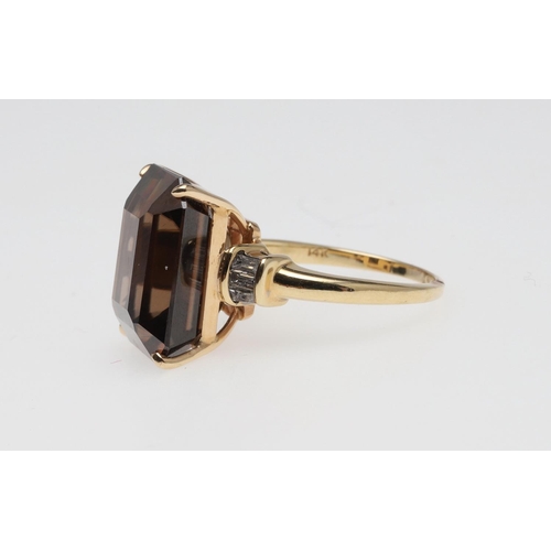 1072 - A ZIRCON AND DIAMOND RING. the step-cut brown zircon is set with three baguette-cut diamonds to each... 