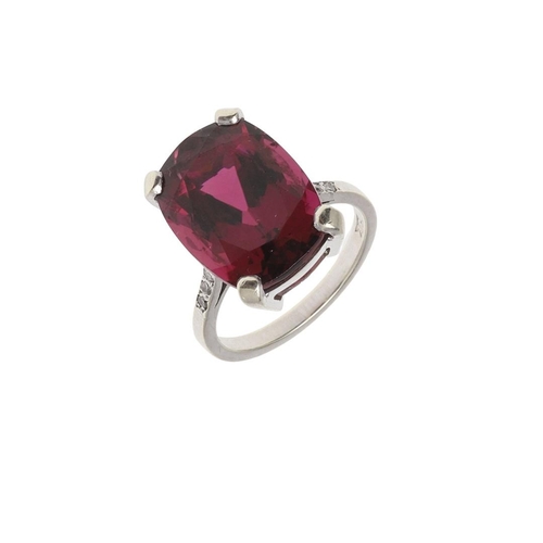 1073 - A TOURMALINE AND DIAMOND RING. the oval-shaped pink tourmaline weighs approximately 11.0 carats and ... 