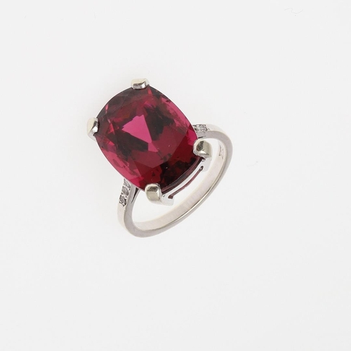 1073 - A TOURMALINE AND DIAMOND RING. the oval-shaped pink tourmaline weighs approximately 11.0 carats and ... 