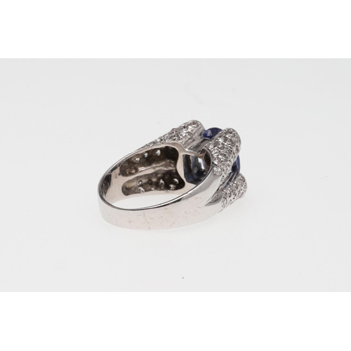 1074 - A SAPPHIRE AND DIAMOND RING. the oval-shaped sapphire is set with two circular-cut diamonds to each ... 