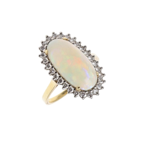 1075 - AN OPAL AND DIAMOND CLUSTER RING. the oval-shaped solid white opal is set within a surround of circu... 