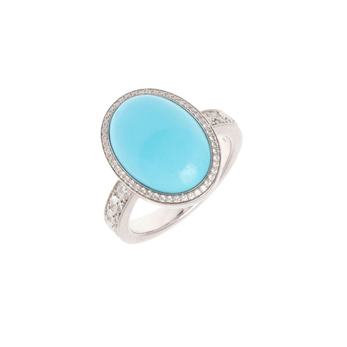 1119 - A TURQUOISE AND DIAMOND CLUSTER RING. the oval-shaped turquoise cabochon is set within a surround of... 