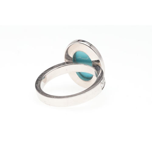 1119 - A TURQUOISE AND DIAMOND CLUSTER RING. the oval-shaped turquoise cabochon is set within a surround of... 