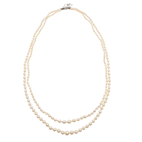 1121 - A DOUBLE ROW GRADUATED NATURAL PEARL NECKLACE. the pearls graduate from approximately 2.3 to 6.9mm a... 