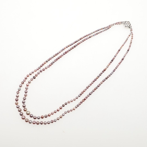 1122 - A GRADUATED DOUBLE ROW NATURAL PEARL NECKLACE. the pearls graduate from approximately 2.0 to 5.6mm a... 