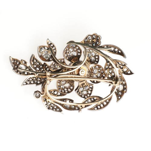 1124 - A VICTORIAN DIAMOND FOLIATE SPRAY BROOCH. the central flowerhead set en tremblant, mounted overall w... 