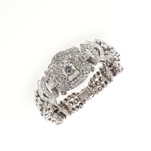 1127 - AN ART DECO DIAMOND BRACELET. formed with geometric and fan-shaped sections, mounted overall with ci... 