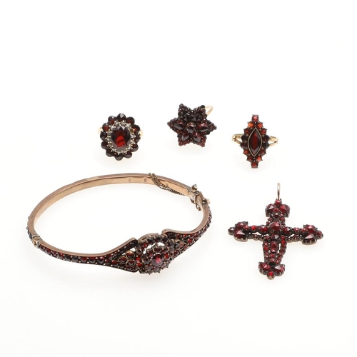 784 - A VICTORIAN GARNET CRUCIFORM PENDANT. mounted overall with faceted pear-shaped and circular-cut garn... 