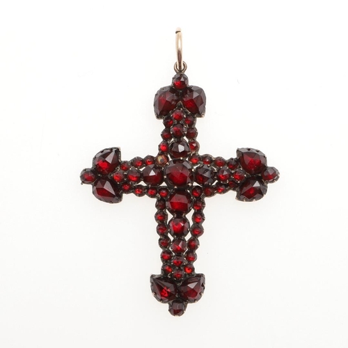 784 - A VICTORIAN GARNET CRUCIFORM PENDANT. mounted overall with faceted pear-shaped and circular-cut garn... 