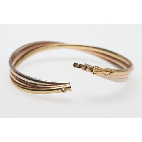 802 - A 15CT GOLD HALF HINGED BANGLE. of oval shape and plain form, internal measurements 5 x 6.2cm., 8.3 ... 