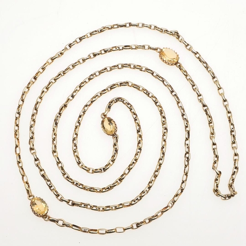 813 - A GOLD AND CITRINE LONG GUARD CHAIN. mounted with oval-shaped links and set with three claw set oval... 